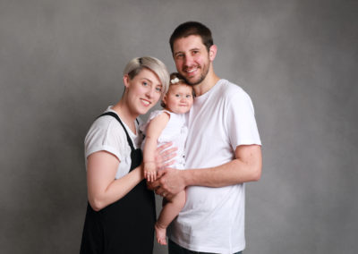 Family Portrait Photoshoot Peekaboo Liverpool young couple smiling toddler grey & white tones