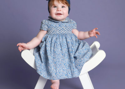 Little sitters baby toddler Photoshoot Peekaboo Liverpool little girl on stool hair bow purple background