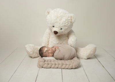 Newborn photoshoot Peekaboo Liverpool sleeping baby with teddy bear creamy neutrals