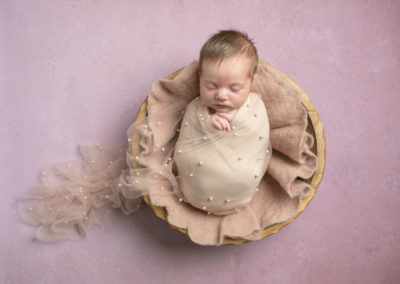 Newborn photoshoot Peekaboo Liverpool pearl fabric draped over baby in bowl