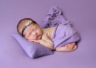 Newborn photoshoot Peekaboo Liverpool lilac pillow and backdrop