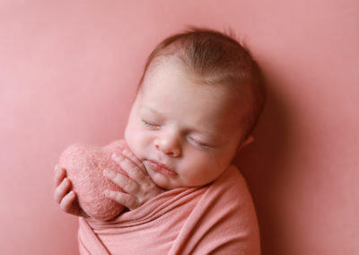 Newborn photoshoot Peekaboo Liverpool baby girl holding pink heart