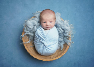 Newborn photoshoot Peekaboo Liverpool baby eyes opens blue wrap