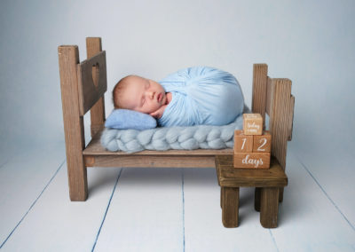 Newborn photoshoot Peekaboo Liverpool baby blue bed