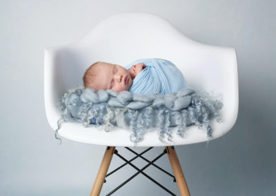 Newborn photoshoot Peekaboo Liverpool baby blue chair
