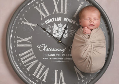 Newborn photoshoot Peekaboo Liverpool baby on clock prop personalised time of birth