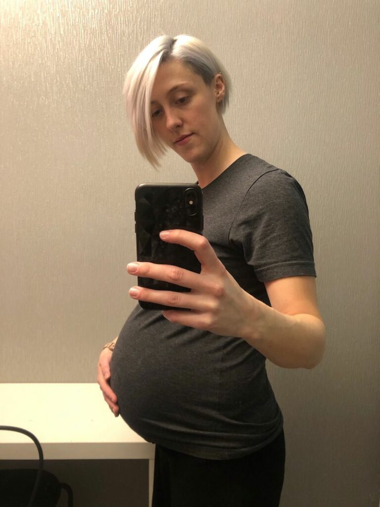 picture of pregnant woman standing in the mirror